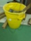 Yellow Rubbermaid trash can