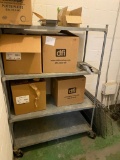 Galvanized shelf on caster w/ misc contents boxes of salad container lids and partial box of plates