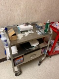 Stainless rolling service cart with contents