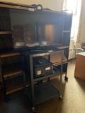 Audio visual cart, projector screen and plastic table. No contents