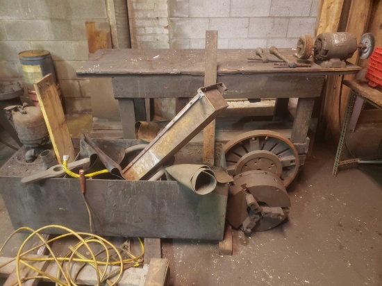 Table with bench grinder and scrap