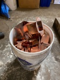 Bucket of assorted copper gutter fittings and clips