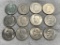 12- Assorted Eisenhower Dollar coins with coin tube