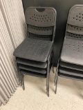 LOT OF 4 BLACK PLASTIC STACKABLE CHAIRS