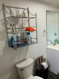 Bathroom Items Including Cleaning Supplies and Wall Rack Above Toilet