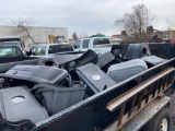 Trailer load of assorted bagger units for mowers.