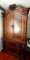 Full Sized Solid Wood Armoire with Ornate Top and Carved Side Detailing