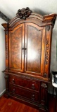 Full Sized Solid Wood Armoire with Ornate Top and Carved Side Detailing