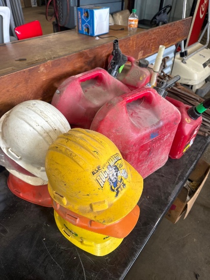 (4) Assorted Gas Cans & (7) Assorted Hard Hats