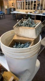 Bucket of assorted carriage bolts and nails