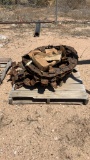 Pallets of ditcher chain, sprockets,  and teeth.