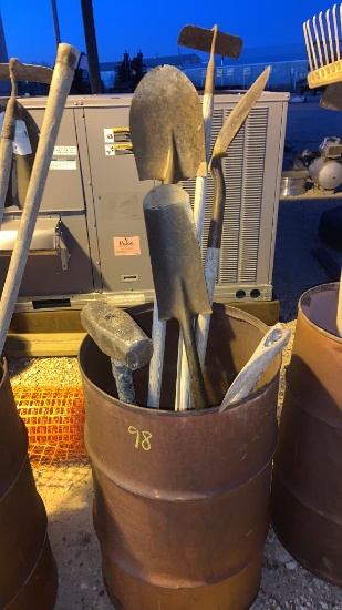 Barrel with shovels, hoe, sledge, axe