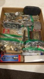 Box of belt buckles,costume jewelry, lighters, &