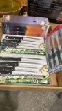 Box of new black handle steak knives