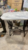 Antique sewing machine base with marble top