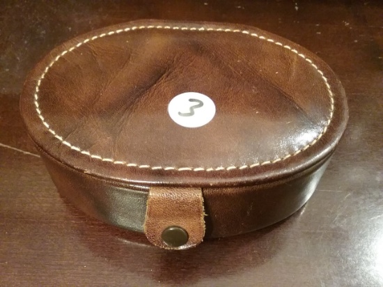 Leather bound box with a lot of foreign coins