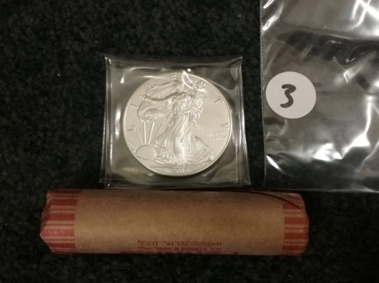 2015 Uncirculated American Silver Eagle and a roll of wheat cents