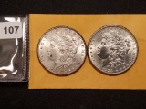 Two About Uncirculated 58 Morgan Dollars