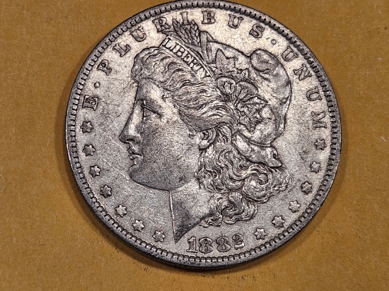 1882-O/S Morgan Dollar in About Uncirculated