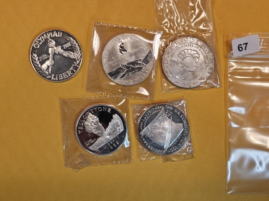 Five mixed Commemorative Silver Dollars