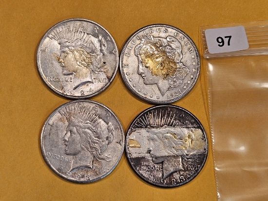 Four mixed Morgan and Peace Silver Dollars