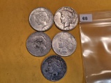 Five mixed Peace Silver Dollars