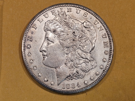 ** KEY DATE ** 1884-CC Morgan Dollar in About Uncirculated - 58 - details
