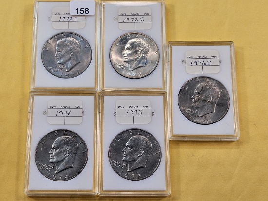 Five Uncirculated Eisenhower Dollars, one Silver
