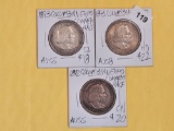 Three About Uncirculated plus Columbian Commemorative half Dollars