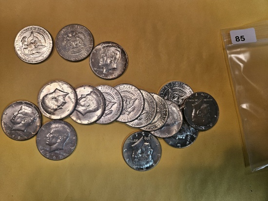 Sixteen mixed silver Kennedy Half Dollars