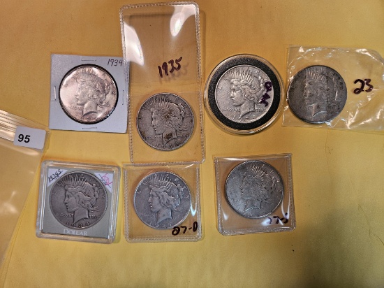 Seven mixed Silver Peace Dollars
