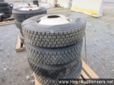 4 - 295/75r22. 5 rear drive tires, 10 hole hub pilot rims on pallet, 42' w