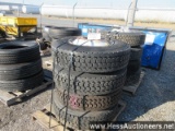 4 - 275/80r22. 5 rear drive tires, 10 hole hub pilot rims on pallet, stock
