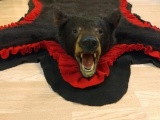 Bear rug with board backing Red and black felt Bear