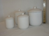 Set of four white ceramic canisters - various sizes