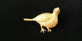 18 kt y/g Quail pin with two (2) ruby eyes. Total weight 13.58 gms.