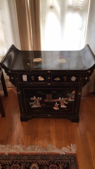 Black lacquer highly decorated oriental cabinet.