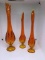 3 orange Viking Glass vases.  Two 12 inch, one 14