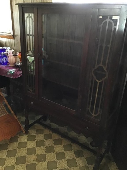 Glass front China cabinet with bottom drawer.