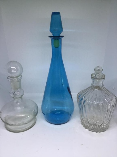 "3 decanters and stoppers.