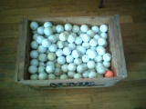 Wooden box full of golf balls