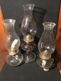 Three oil lamps. 13 and 15 inches