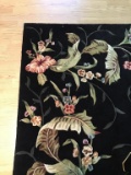 Beautiful black and floral wool rug..  9 ft x 7.6