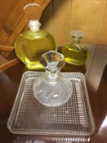 Perfume bottles and square glass dresser tray