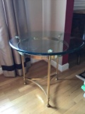 Glass and brass end table.  23 inches tall. Top