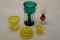 Three Yellow Glass Items Together With A Small Red Based Lamp and a Green G