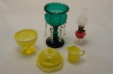 Three Yellow Glass Items Together With A Small Red Based Lamp and a Green G