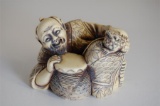 19th Century Carved Ivory Ivorine Okimono of Street Musician Laying with a