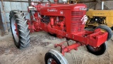 Farmall M pulling tractor