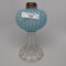 #1 stand lamp in Sheldon Swirl pattern. Blue opal font with clear stem and